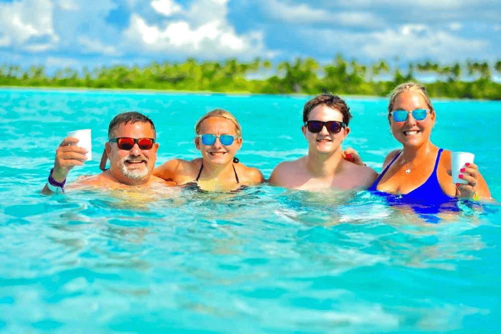 Happy family in the turquoise Saona natural pool