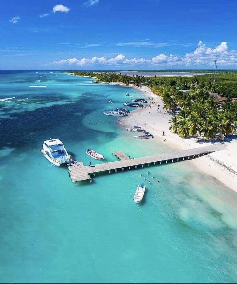 Saona Island beach with turquoise water and excursion boats in Bayahibe, Dominican Republic